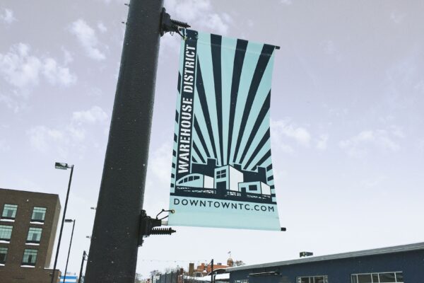 Installed powder-coated BannerSaver brackets on a light pole.