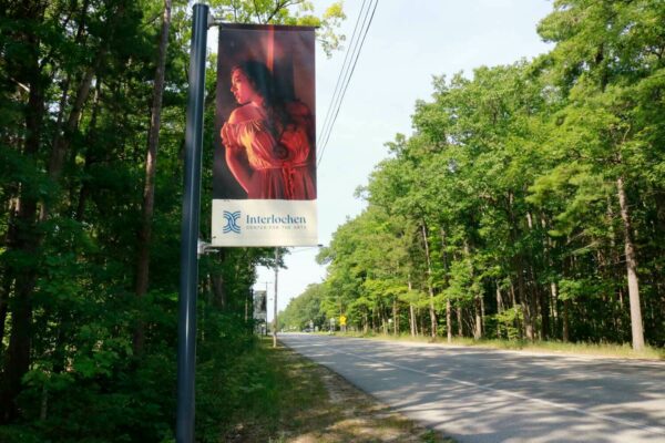 BannerSaver lamp post brackets holding a custom printed banner at Interlochen Arts Academy.